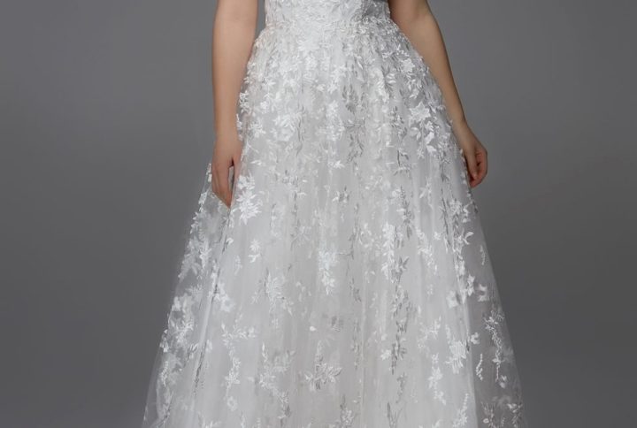 Bride in lace wedding dresses Omaha NE boutique with intricate lace detail on bodice and sleeves