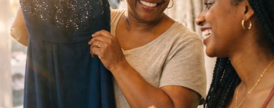 Mother helping her daughter choose from vintage wedding dresses at an Omaha bridal shop fitting room