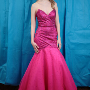 Make a bold and elegant statement in this fuchsia strapless trumpet dress, featuring stunning beading and a dramatic flare. Strapless fuchsia trumpet prom dress with intricate beading and a flattering silhouette.