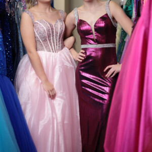 From fairytale romance to sleek sophistication—choose between a dreamy pink corset ballgown or a shimmering metallic fitted dress with dazzling beaded accents. Pink corset top ballgown and metallic fitted prom dress with beaded straps and waistband for a glamorous look.