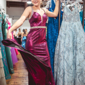 Shine from every angle in this metallic fitted prom dress, featuring sparkling beaded rhinestone straps and a matching belt for the perfect touch of elegance. Metallic fitted prom dress with beaded rhinestone straps and belt for a sleek and radiant look.